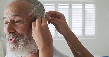 Mature man with hearing aid