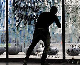 Silhouette Of Artist Painting Glass Window