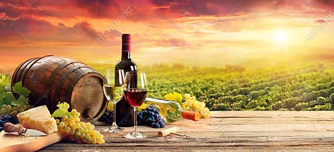 Barrel Wineglasses Cheese And Bottle In Vineyard