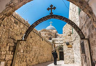 A pilgrim wearing black robe, and walking into St. Anthony Coptic Monastery