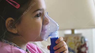 Childhood asthma inhaling mask illnesses little baby girl with flu id doing aerosol independently