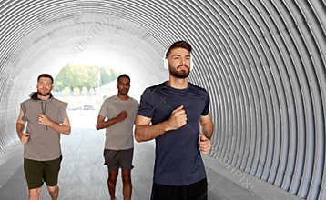 Male friends with headphones running outdoors