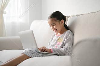 Back to School. asian Little girl using his laptop