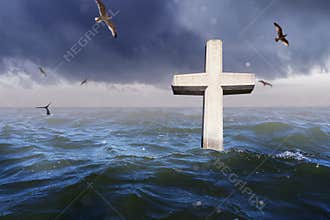 Christian cross stands in the sea