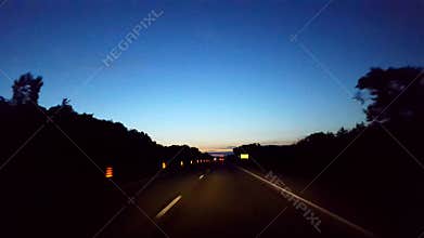 Driving Morning Highway With Light on Horizon.  Driver Point of View POV Interstate Driving Early in the Morning.  Motorway