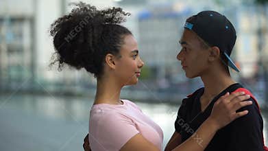 Black couple of teenagers hugging during outdoor date, love connection affection