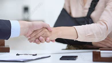 Woman with arm sling shaking lawyers hand, compensation after medical negligence