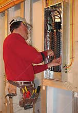 Electrician make connections in panel box