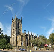 Street view of people and traffic passing of christ church in sowerby bridge west yorkshire