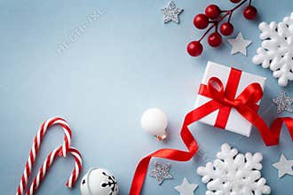 Christmas flat lay. Gift or present box, white snowflakes and holiday decoration top view. Happy New Year card