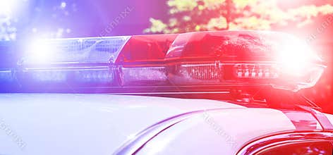 Police force department in full activity. Red light flasher of a patrol police car at sunday. Police patrolling the city.