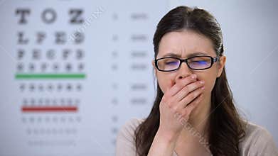 Sleepy female patient yawning, waiting for appointment, poor service quality