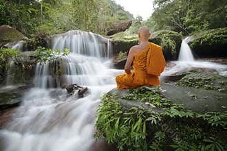 Buddha monk practice meditation at  waterfall