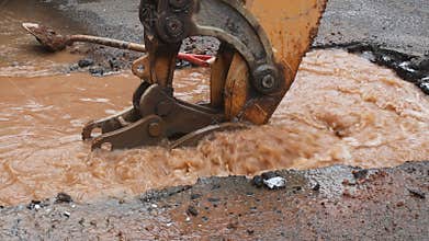 Water pipe break, leaking from hole in a road