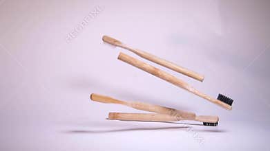 No plastic conscious minimalism vegan lifestyle. Reduce reuse recycle slowmotion concept. Eco friendly toothbrush falling on a whi