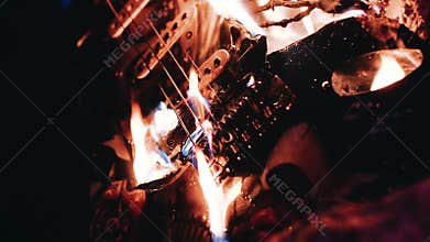 Burning electric guitar. Close-up of a burning guitar. Beautiful moment. Apocalypse.