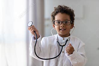 Cute african kid boy wear medical uniform playing doctor, portrait