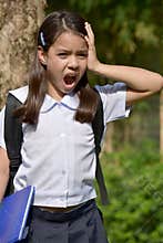 Asian Girl Student Under Stress Wearing Uniform With Books