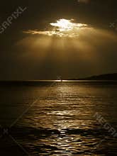 God's rays and a boat on the sea