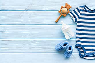 Baby background - blue color. Clothes and accessories for newborn boy on blue wooden table top-down frame copy space
