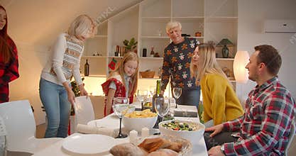 Big Caucasian family sits down a Christmas table evening dinner union joy smile conversation home comfort