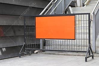 Steel barrier with orange label placed across the stairs.