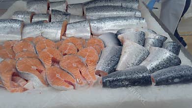 Red salmon fish in ice at fish shop counter