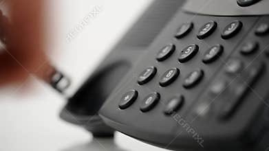 Male hand dialing telephone number