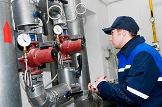 Heating engineer in boiler room
