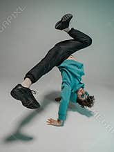 Boy dancing contemporary dance in studio. Acrobatic dancer.