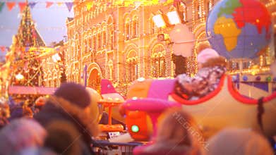 Unknown adults and kids visit New Year and Christmas Bazaar on the Red Square in Moscow, Russia