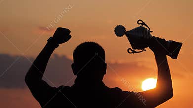 Silhouette best man Winner Award victory trophy for professional champion challenge holding trophy cup over head with