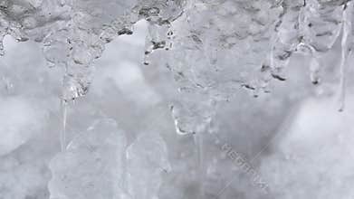 Winter or spring background icicles icy dripping flowing water melting ice looped video