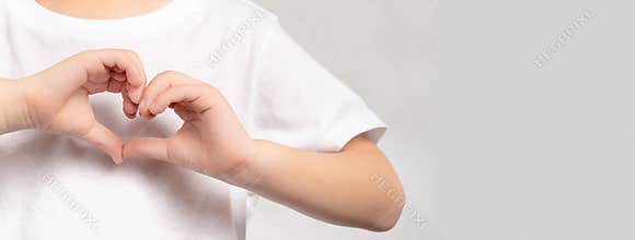 An adorable little child`s hands gesture in heart shape showing love and kindness. Concept of Health care, Charity, Organ Donatio