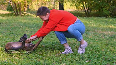 Young woman is playing with her pet