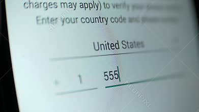 Someone dials touchscreen a phone number for verification in the application.