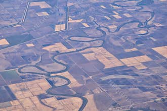 Mississippi River aerial landscape views from airplane over the border of Arkansas and Mississippi. Winding river and Rural town a