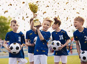 Happy kids in elementary school sports team celebrating soccer succes in tournament final game