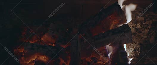 Fire behind a dirty glass in the fireplace