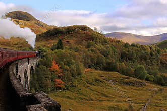 Steam train crossing Glenfinnan Viaduct, Scotland