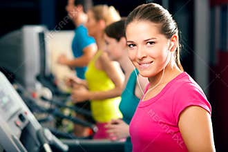 People on treadmill in gym running