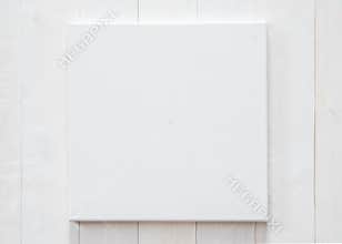 White blank canvas mockup square size on white wood wall for arts painting and photo hanging