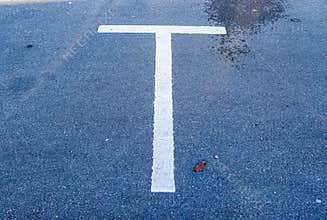 Different signs and marking painted on the ashpalt of streets and roads