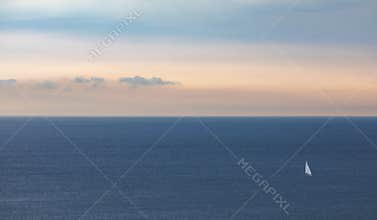 Yacht on a calm sea at sunset
