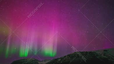 Aurora borealis in night northern sky. Ionisation of air particles in the upper atmosphere.