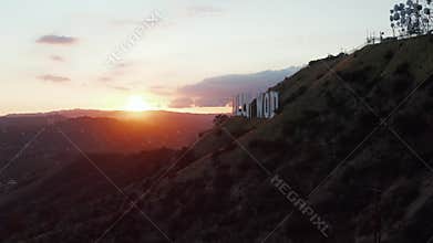 AERIAL: Hollywood Hills in Beautiful Sunset Golden Hour Light and view on Hollywood Sign on Mountain side in Los Angeles