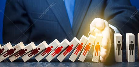 Man stops fall of dominoes represents infected people. COVID-19 virus pandemic. Stop new infections. Quarantine. Stop spread