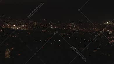 AERIAL: Barcelona Drone Shot at Night with Beautiful Hill and City Traffic lights