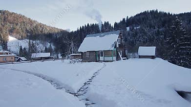 Dreamlike winter scenery - cozy solitary log hut with smoking