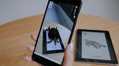 Woman using tablet with augmented reality app - virtual 3d models of animals